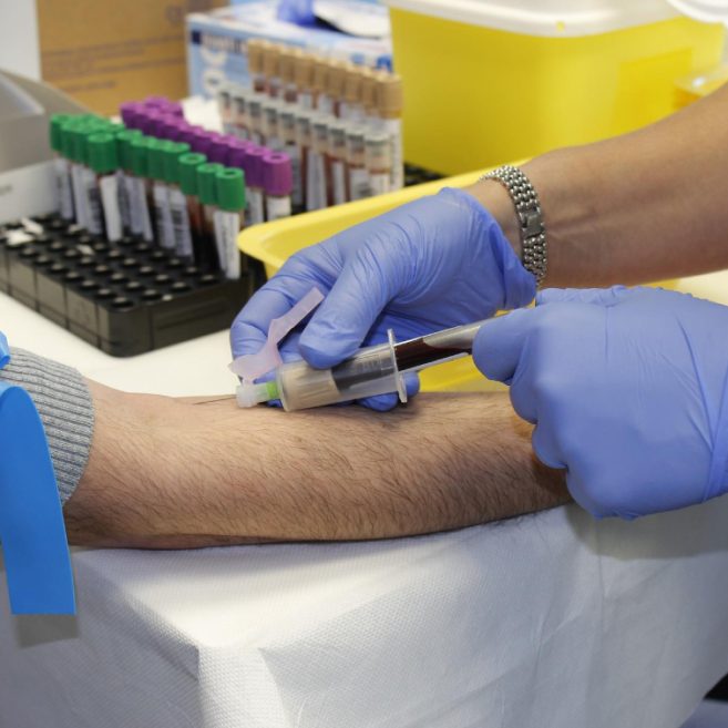 Lab worker taking blood sample